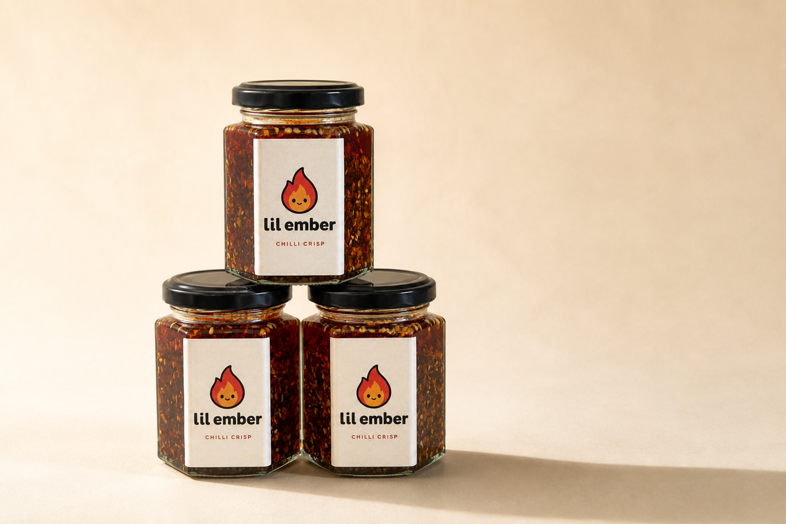 Lil Ember three-jar product campaign image in the warm cream studio